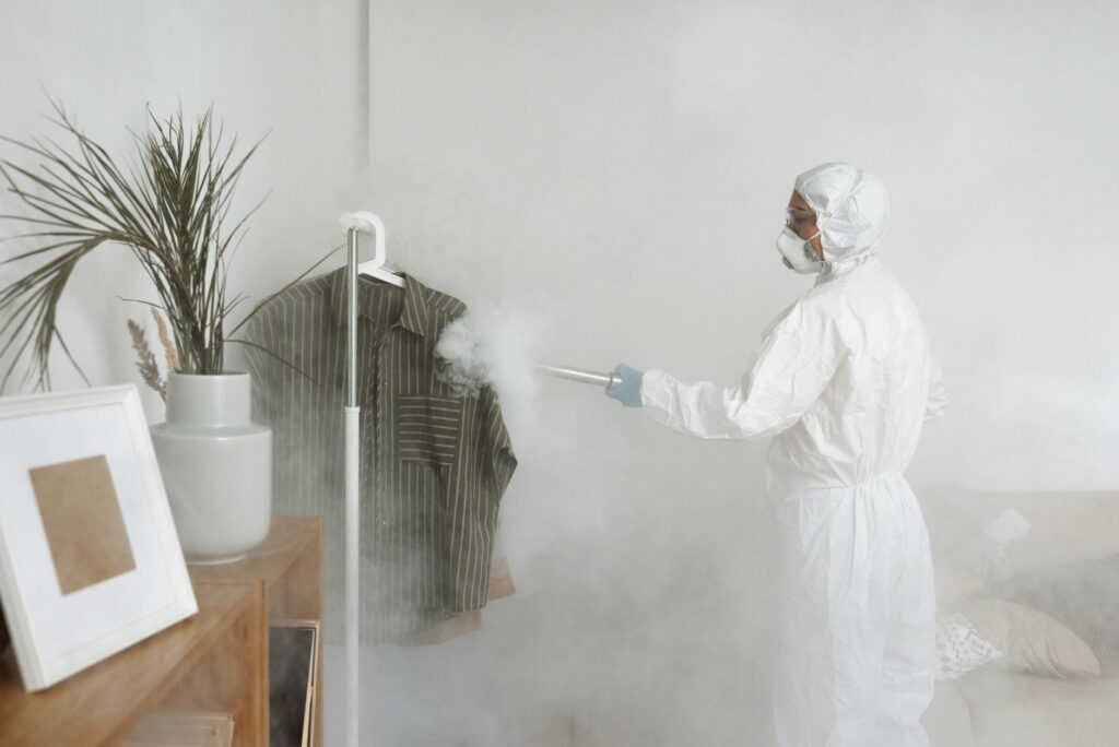 Mold remediation and biohazard cleanup technician in protective PPE suit treating a home — Ready Restore OC, Orange County