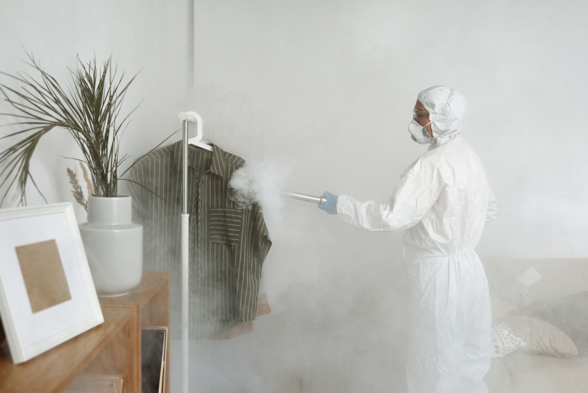 Mold remediation and biohazard cleanup technician in protective PPE suit treating a home — Ready Restore OC, Orange County